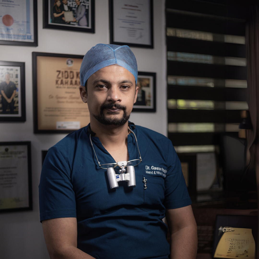 Dr. Gaurav Pagare in his clinic, specializing in hand surgery, with awards and certificates displayed in the background.